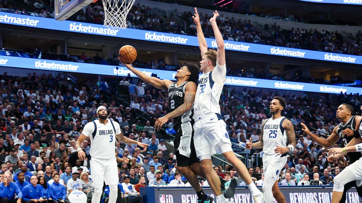 San Antonio Spurs guard Dylan Harper (2) shoots past Dallas Mavericks forward Cooper Flagg (32) during the second half at American Airlines Center.