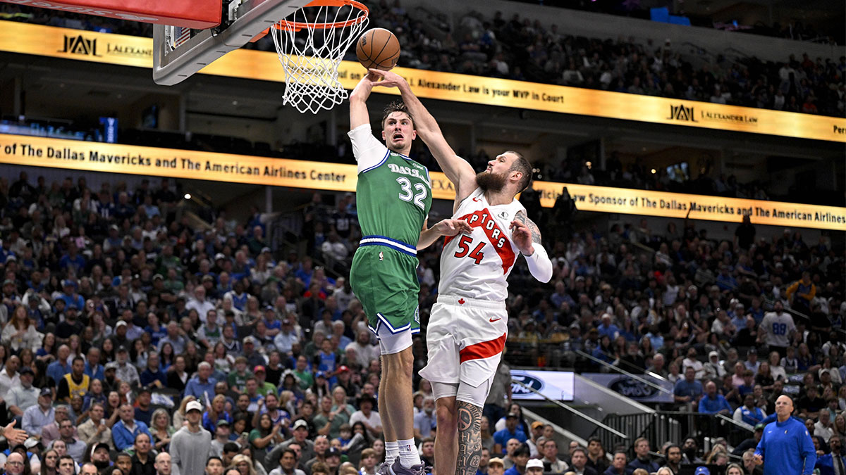 Dallas Mavericks forward Cooper Flagg (32) dunks the ball past Toronto Raptors forward Sandro Mamukelashvili (54) during the third quarter at the American Airlines Center.