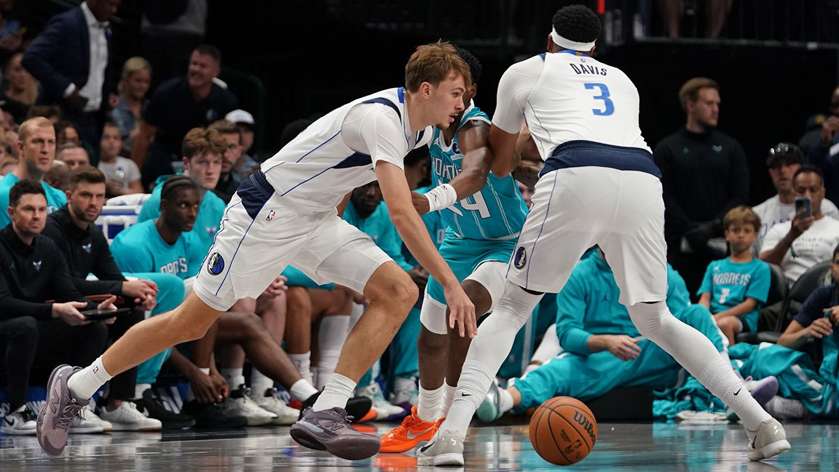 Dallas Mavericks forward Cooper Flagg (32) works around the pick set by forward/center Anthony Davis (3) on Charlotte Hornets forward Brandon Miller (24) in the first half of a game at American Airlines Center.