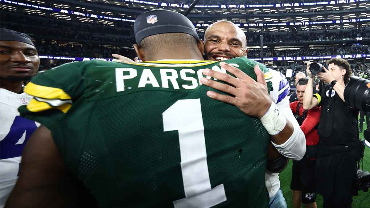 Packers defensive end Micah Parsons (1) and Dallas Cowboys quarterback Dak Prescott (4) embrace after the tie game at AT&T Stadium