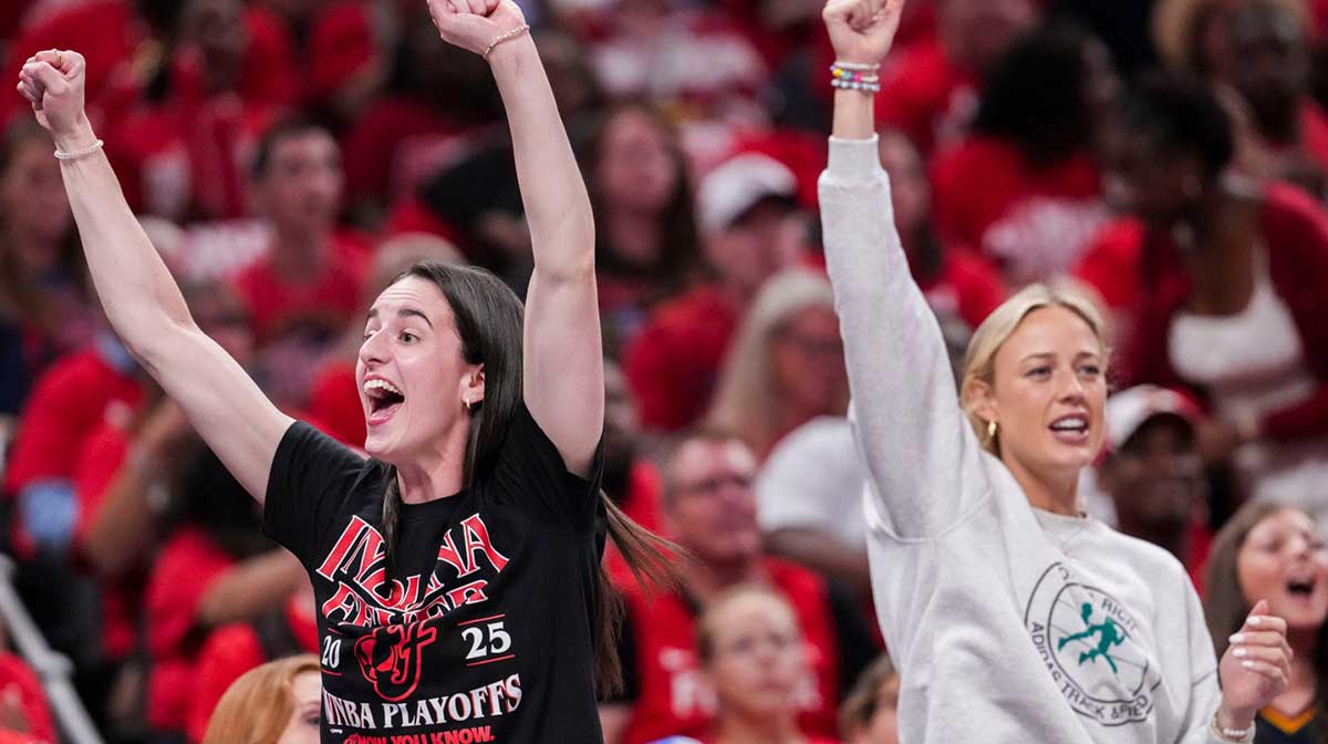 Indiana Fever guard Caitlin Clark (22) and Indiana Fever guard Sophie Cunningham (8) celebrate from the bench Tuesday, Sept. 16, 2025, during Game 2 of a WNBA playoff matchup between the Indiana Fever and the Atlanta Dream at Gainbridge Fieldhouse in Indianapolis.