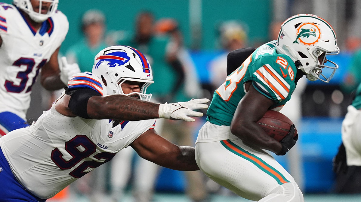 Miami Dolphins running back De'Von Achane (28) runs the ball away from Buffalo Bills defensive tackle DaQuan Jones (92) during the first half at Hard Rock Stadium.