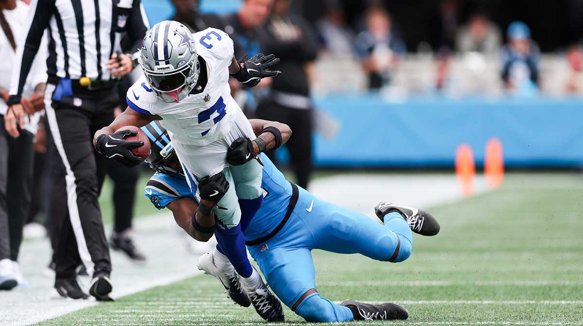 Dallas Cowboys wide receiver George Pickens (3) is tackled by Carolina Panthers cornerback Mike Jackson (2) during the second half at Bank of America Stadium.