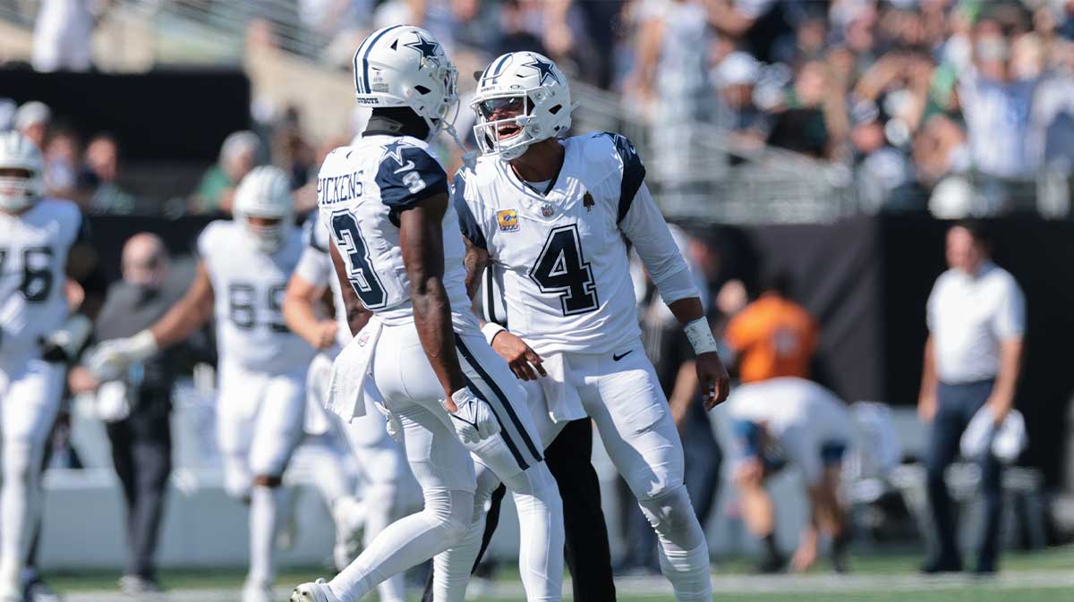 Dallas Cowboys quarterback Dak Prescott (4) reacts with wide receiver George Pickens (3) after throwing a touchdown pass against the New York Jets during the first half at MetLife Stadium.