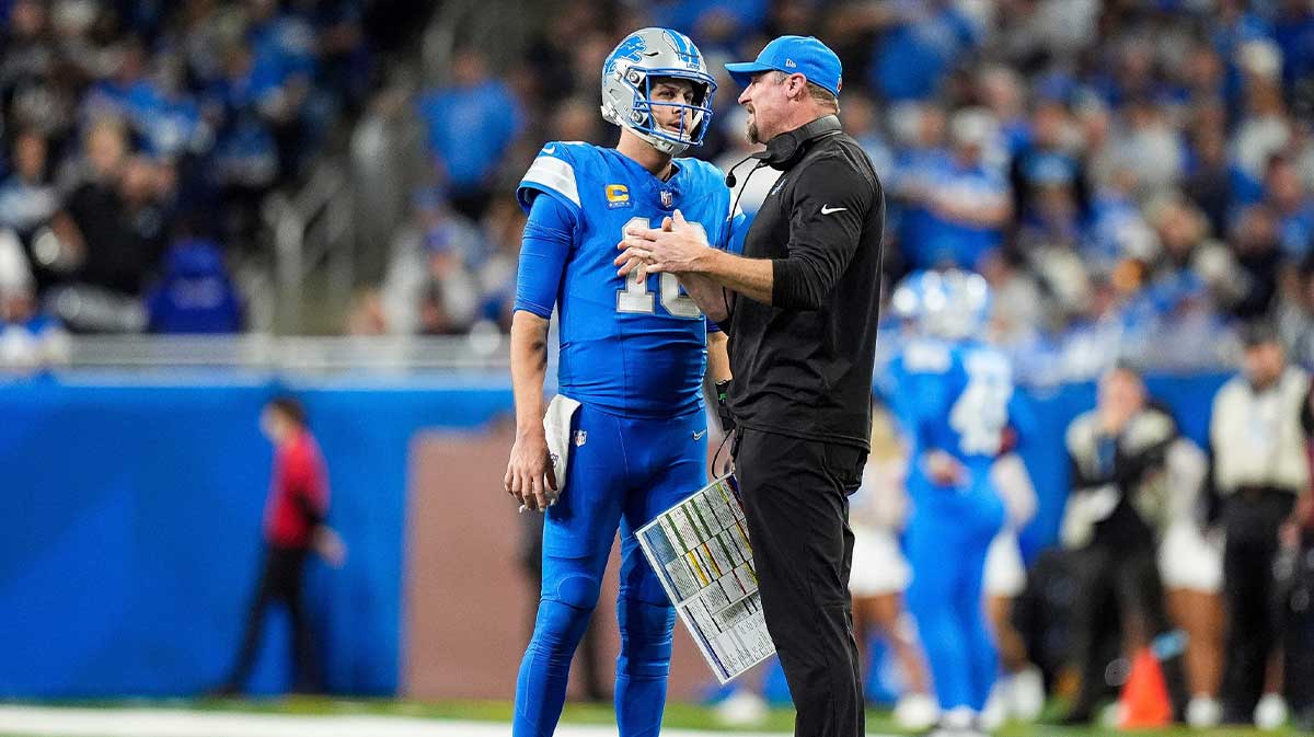 Detroit Lions quarterback Jared Goff (16) talks to head coach Dan Campbell before a play against Green Bay Packers during the second half at Ford Field in Detroit on Thursday, Dec. 5, 2024.