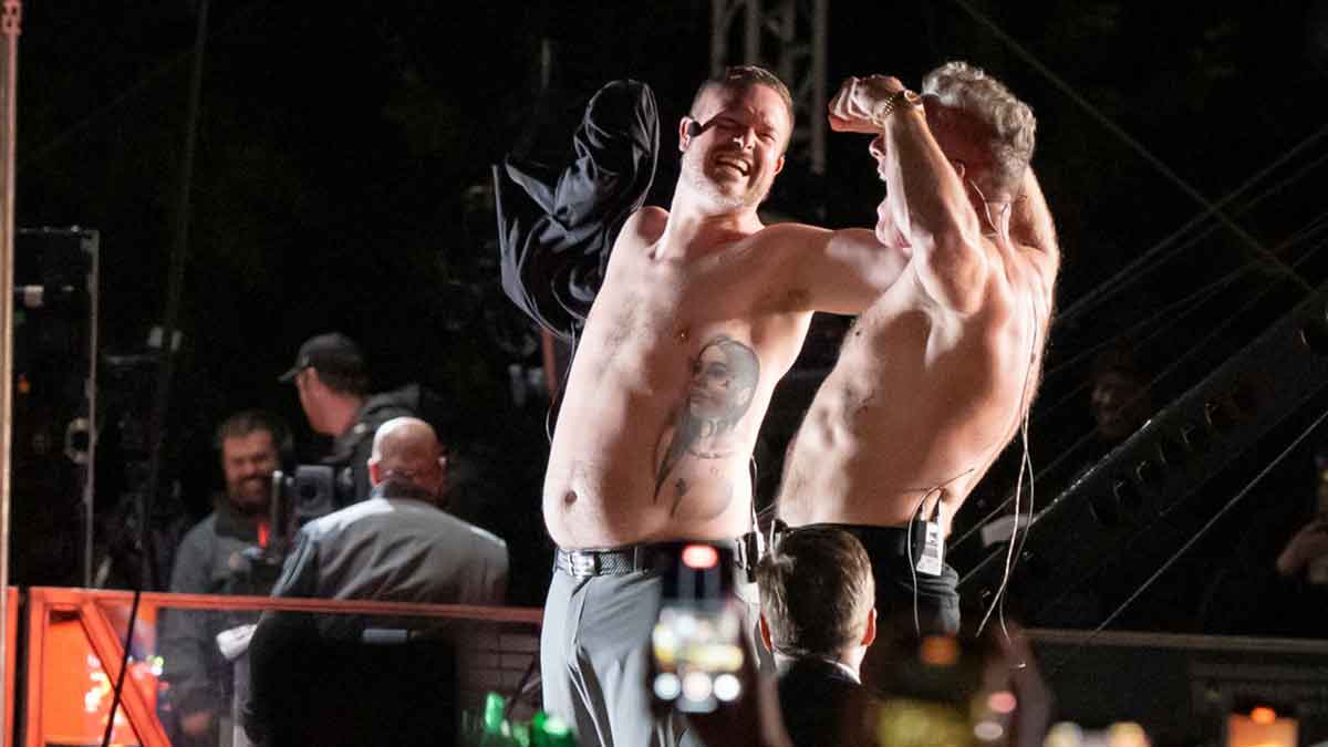 Oregon head coach Dan Lanning, left, and host Pat McAfee strip off their shirts to rally the crowd during ESPN’s “College GameDay” on the campus of the University of Oregon on Oct. 11, 2025, in Eugene, Oregon.