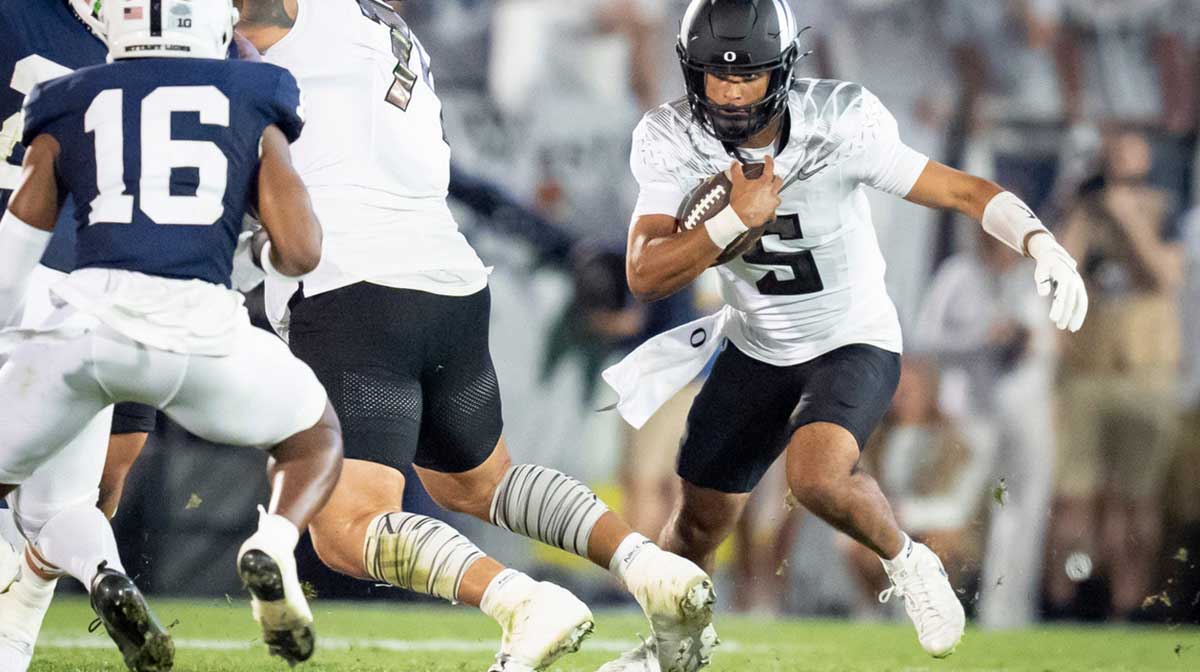Oregon quarterback Dante Moore carries the ball as the Oregon Ducks face the Penn State Nittany Lions on Sept. 27, 2025, at Beaver Stadium in University Park, Pennsylvania.