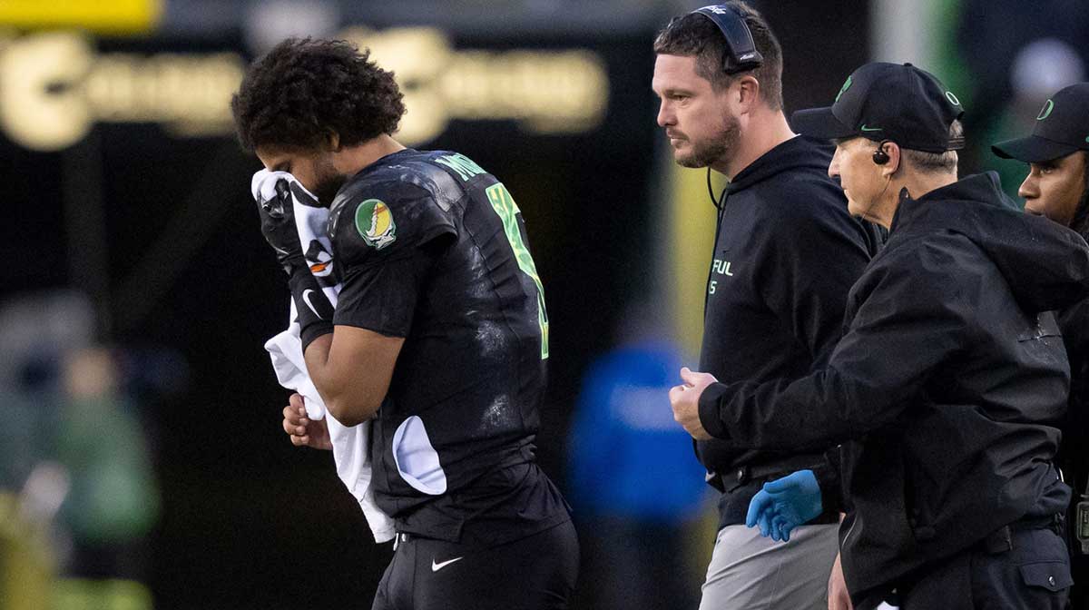 Oregon quarterback Dante Moore walks off the field holding his nose as the Oregon Ducks host the Wisconsin Badgers on Oct. 25, 2025, at Autzen Stadium in Eugene, Oregon.
