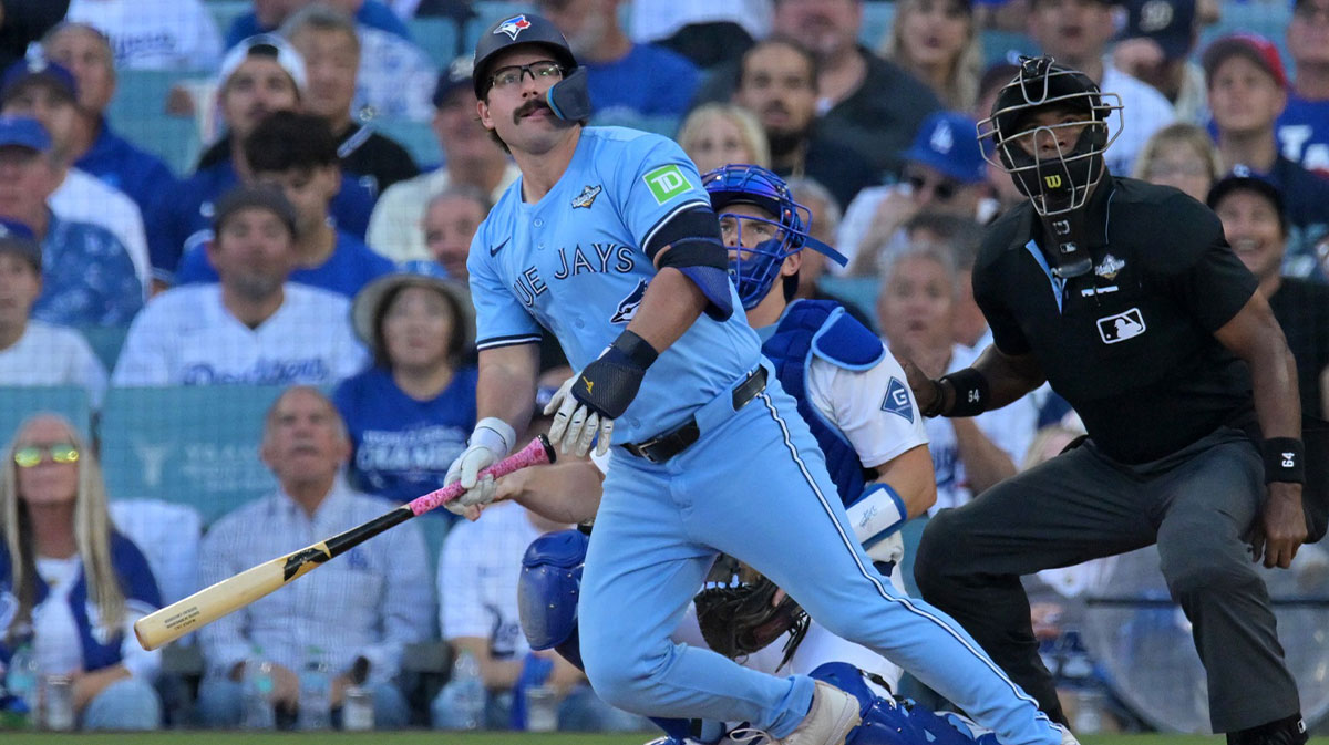 Toronto Blue Jays left fielder Davis Schneider (36) hits a home run against the Los Angeles Dodgers in the first inning during game five of the 2025 MLB World Series at Dodger Stadium.