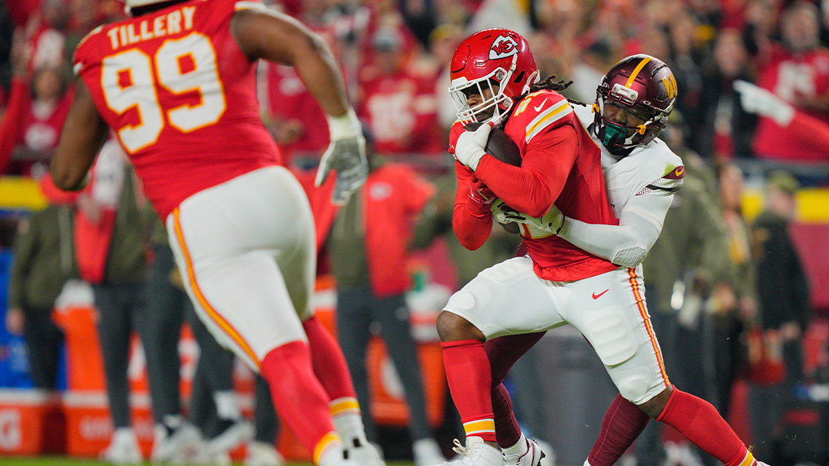 Washington Commanders wide receiver Deebo Samuel Sr. (1) tackles Kansas City Chiefs defensive end Michael Danna (51) after an interception during the first quarter of the game at GEHA Field at Arrowhead Stadium.