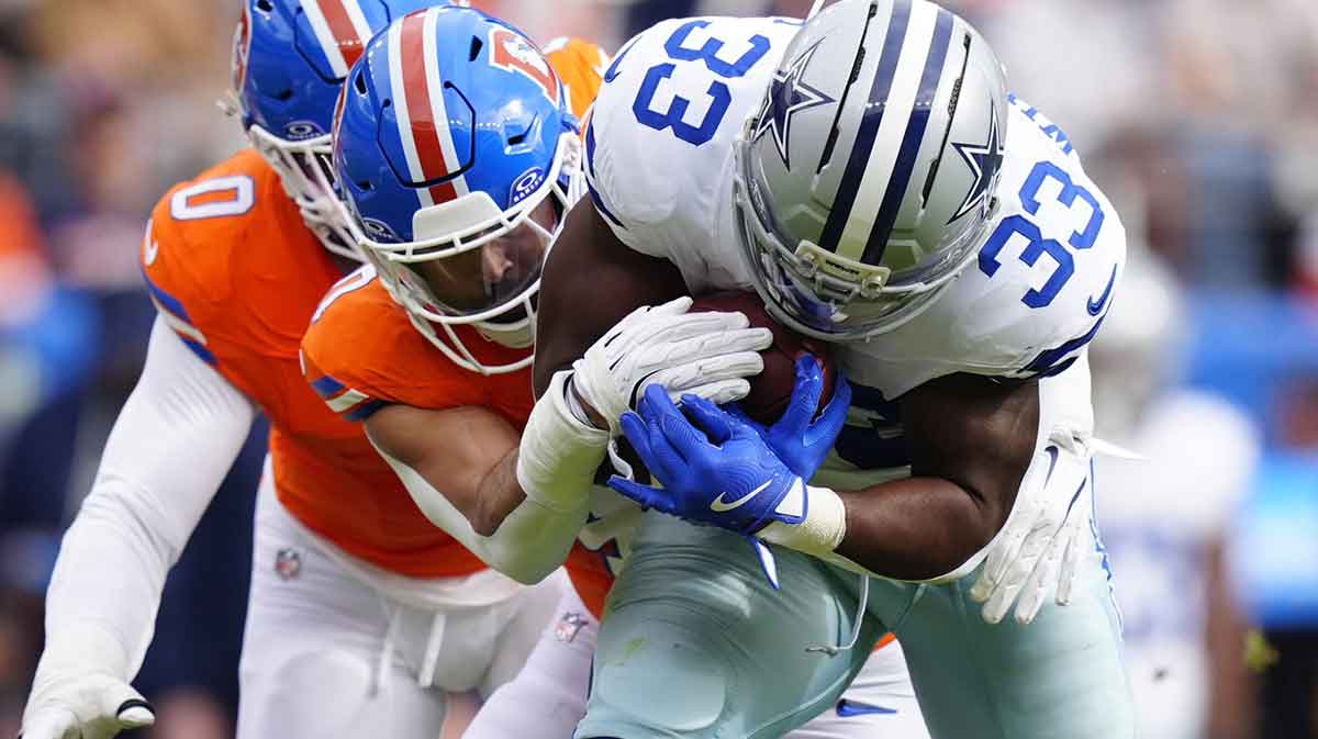 Denver Broncos linebacker Justin Strnad (40) tackles Dallas Cowboys running back Javonte Williams (33)