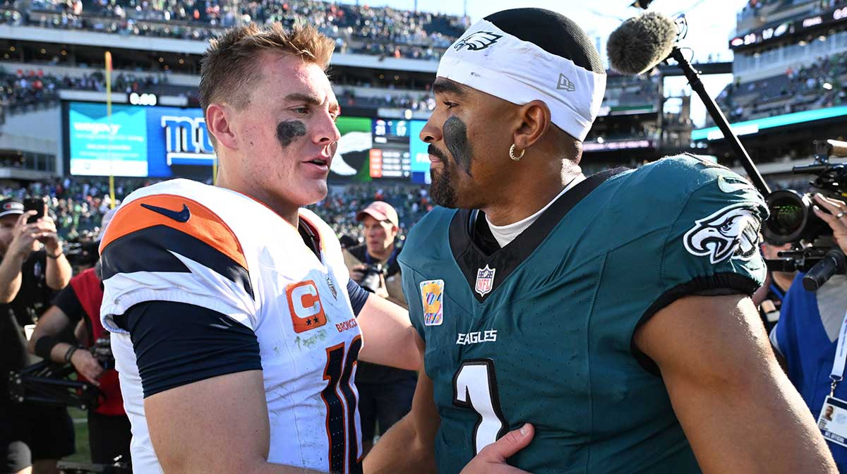 Denver Broncos quarterback Bo Nix (10) and Philadelphia Eagles quarterback Jalen Hurts (1) meet after the game at Lincoln Financial Field.