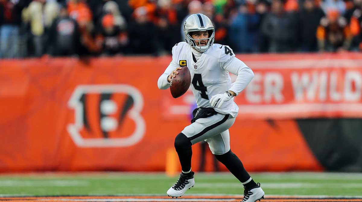 Las Vegas Raiders quarterback Derek Carr (4) runs with the ball against the Cincinnati Bengals in the first half in an AFC Wild Card playoff football game at Paul Brown Stadium.
