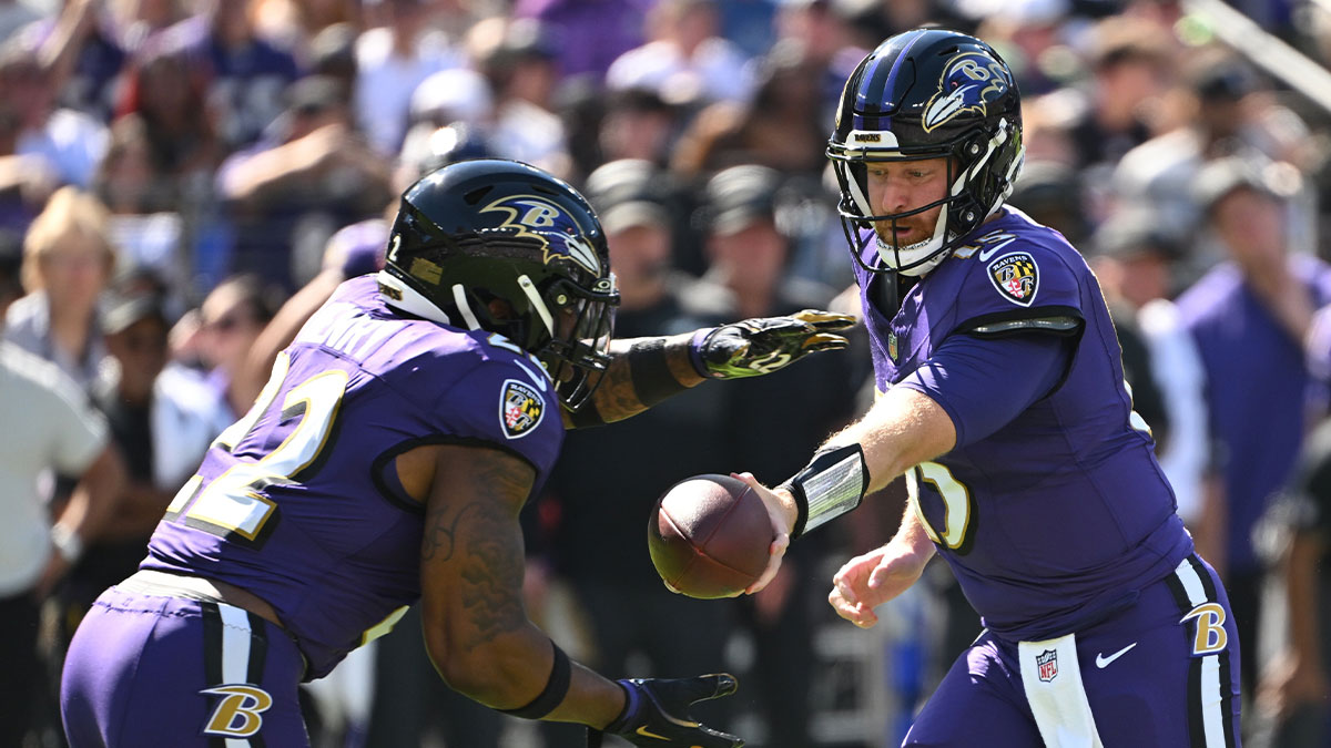 Baltimore Ravens quarterback Cooper Rush (15) hands the ball off to running back Derrick Henry (22) during the first quarter against the Houston Texans at M&T Bank Stadium.