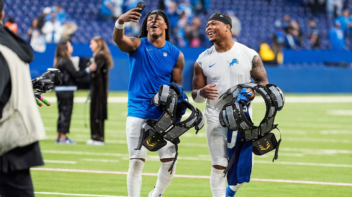 Detroit Lions running back Jahmyr Gibbs (26), left, and running back David Montgomery (5) record a video to celebrate 24-6 win over Indianapolis Colts at Lucas Oil Stadium in Indianapolis, Ind. on Sunday, Nov. 24, 2024.