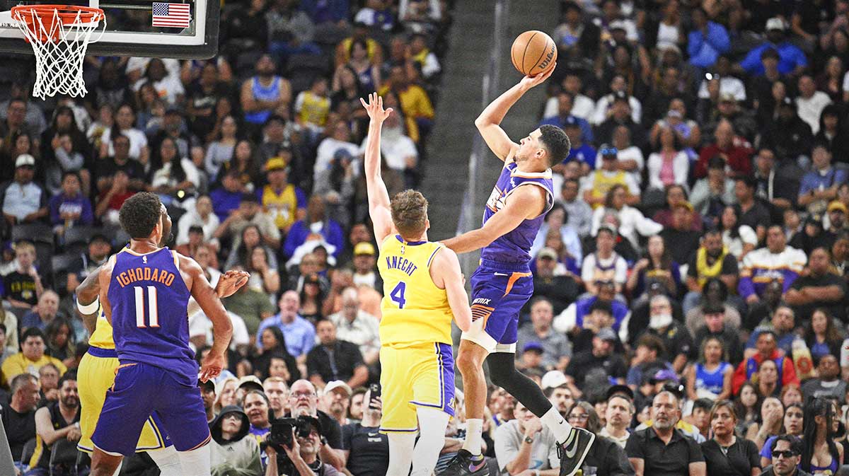 Phoenix Suns guard Devin Booker (1) shoots over Los Angeles Lakers guard Dalton Knecht (4) during the first half at Acrisure Arena.