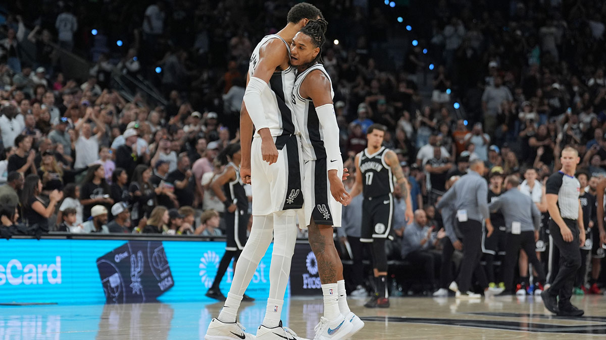 San Antonio Spurs forward Victor Wembanyama (1) and San Antonio Spurs guard Devin Vassell (24) celebrate in the second half against the Brooklyn Nets at Frost Bank Center.