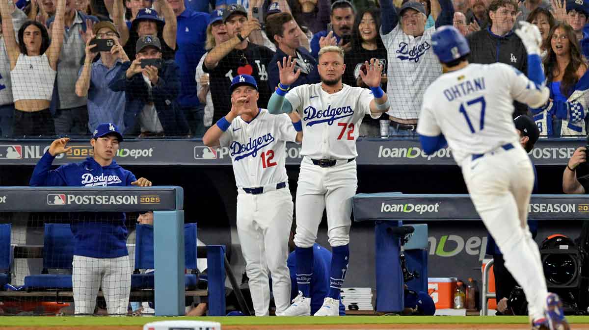 Los Angeles Dodgers second baseman Hyeseong Kim (6), right fielder Alex Call (12) second baseman Miguel Rojas (72) celebrate as two-way player Shohei Ohtani (17) rounds the bases after hitting a solo home run during the fourth inning of game five of the NLCS in the 2025 MLB playoffs against the Milwaukee Brewers at Dodger Stadium.