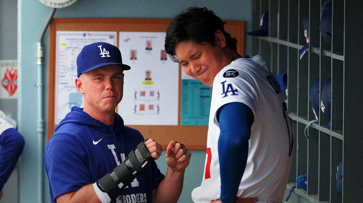 ; Los Angeles Dodgers injured catcher Will Smith (left) with his right hand in a brace talks with designated hitter Shohei Ohtani (17) during the eighth inning against the San Francisco Giants at Dodger Stadium.