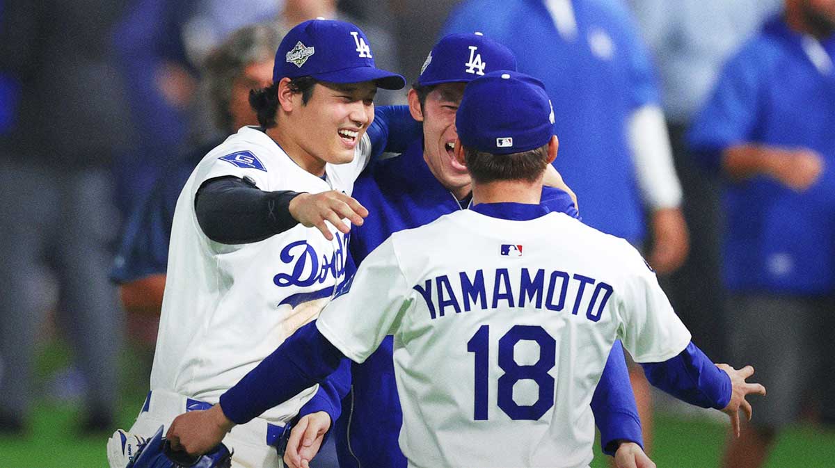 Los Angeles Dodgers designated hitter Shohei Ohtani (17) celebrates with pitcher Roki Sasaki (11) and pitcher Yoshinobu Yamamoto (18) after winning in the eighteenth inning against the Toronto Blue Jays in game three of the 2025 MLB World Series at Dodger Stadium.