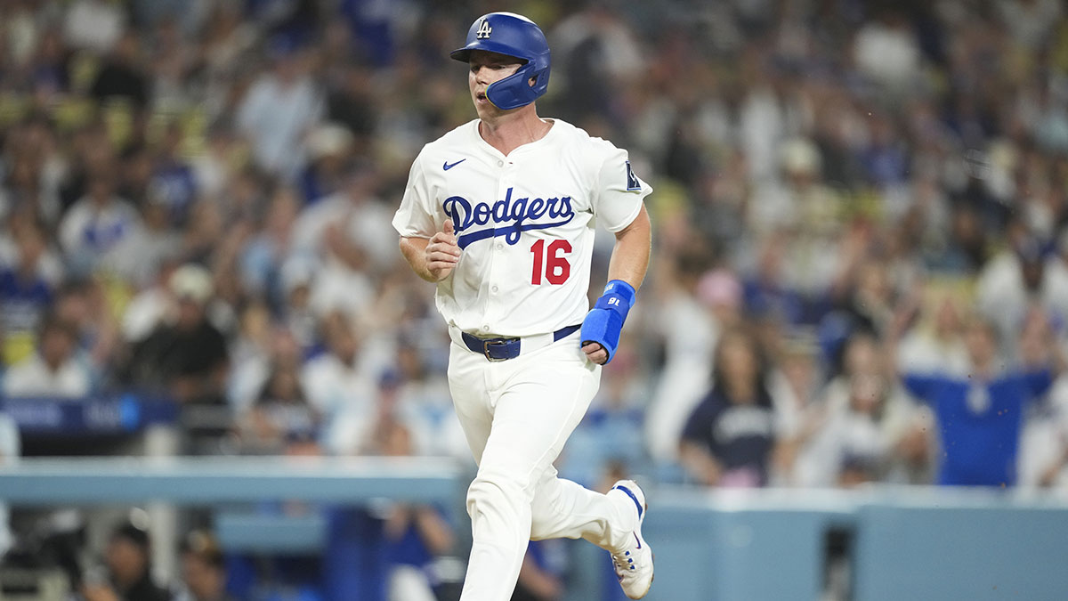 Los Angeles Dodgers catcher Will Smith (16) scores on a wild pitch against the Colorado Rockies during the second inning of the game at Dodger Stadium.