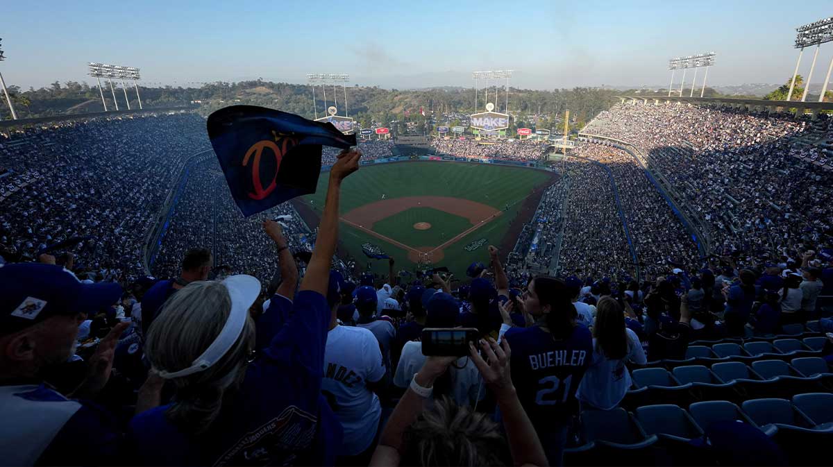 A fan waves a towel before game three of the 2025 MLB World Series between the Toronto Blue Jays and Los Angeles Dodgers at Dodger Stadium.