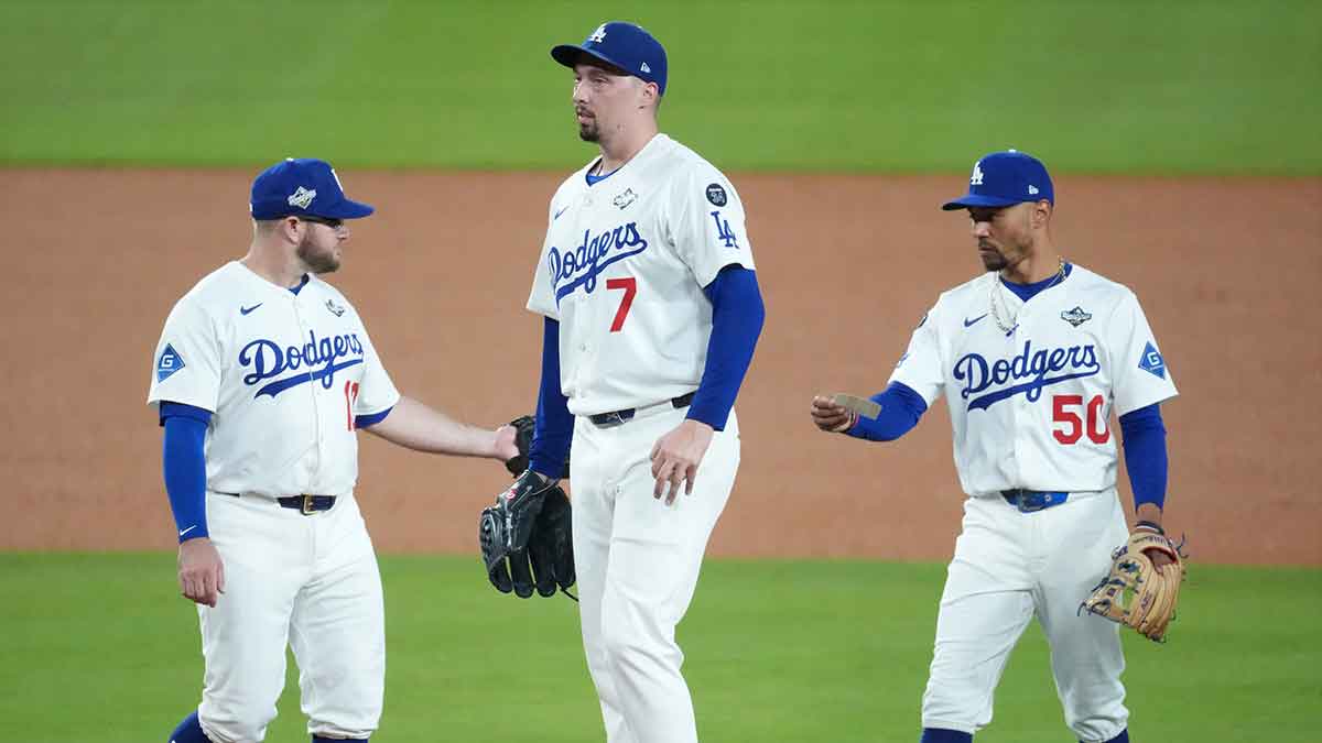Los Angeles Dodgers pitcher Blake Snell (7) reacts on the mound with third baseman Max Muncy (13) and shortstop Mookie Betts (50) in the seventh inning during game five of the 2025 MLB World Series at Dodger Stadium.