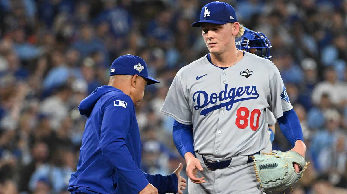 Los Angeles Dodgers manager Dave Roberts (30) takes the ball from pitcher Emmet Sheehan (80) in the sixth inning during game one of the 2025 MLB World Series against the Toronto Blue Jays at Rogers Centre.