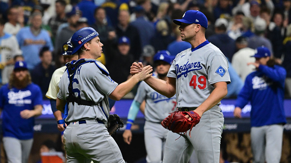 Los Angeles Dodgers catcher Will Smith (16) and relief pitcher Blake Treinen (49) react after defeating the Milwaukee Brewers during game one of the NLCS round for the 2025 MLB playoffs at American Family Field.