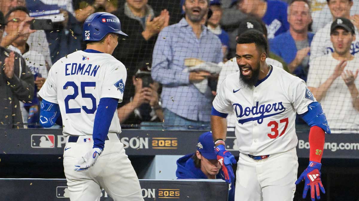 Los Angeles Dodgers second baseman Tommy Edman (25) celebrates with Los Angeles Dodgers right fielder Teoscar Hernández (37) after hitting a solo home run during the third inning against the Philadelphia Phillies during game three of the NLDS round for the 2025 MLB playoffs at Dodger Stadium.