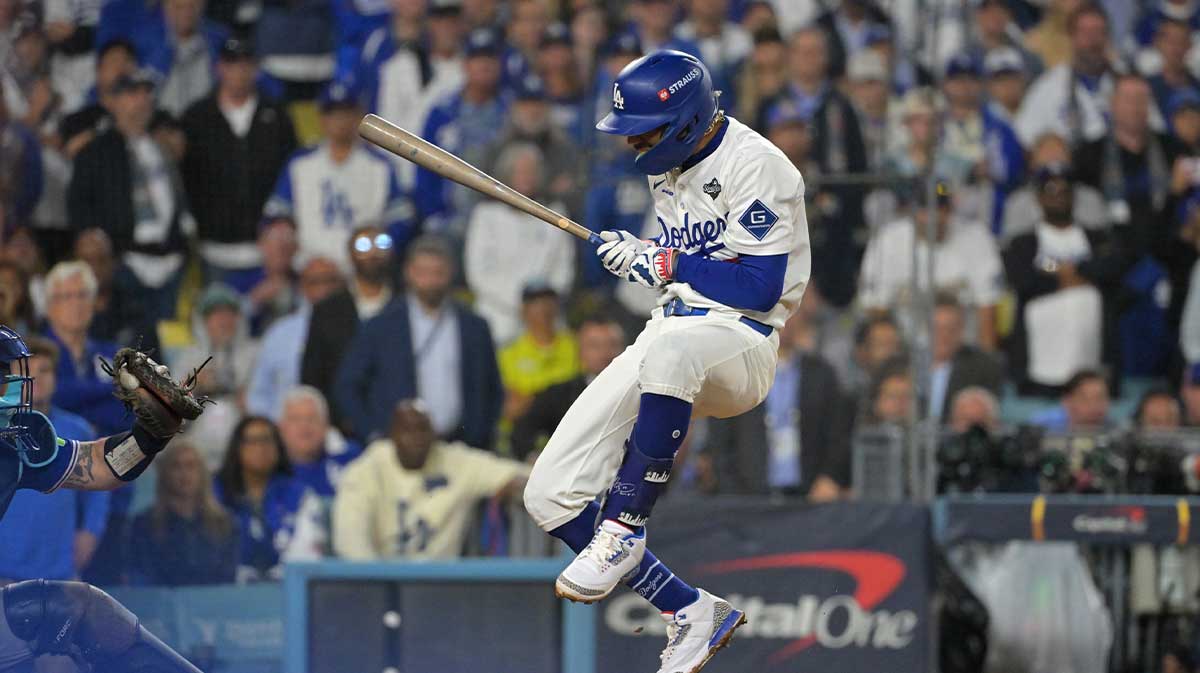 Los Angeles Dodgers shortstop Mookie Betts (50) avoids a pitch in the fifteenth inning against the Toronto Blue Jays during game three of the 2025 MLB World Series at Dodger Stadium.