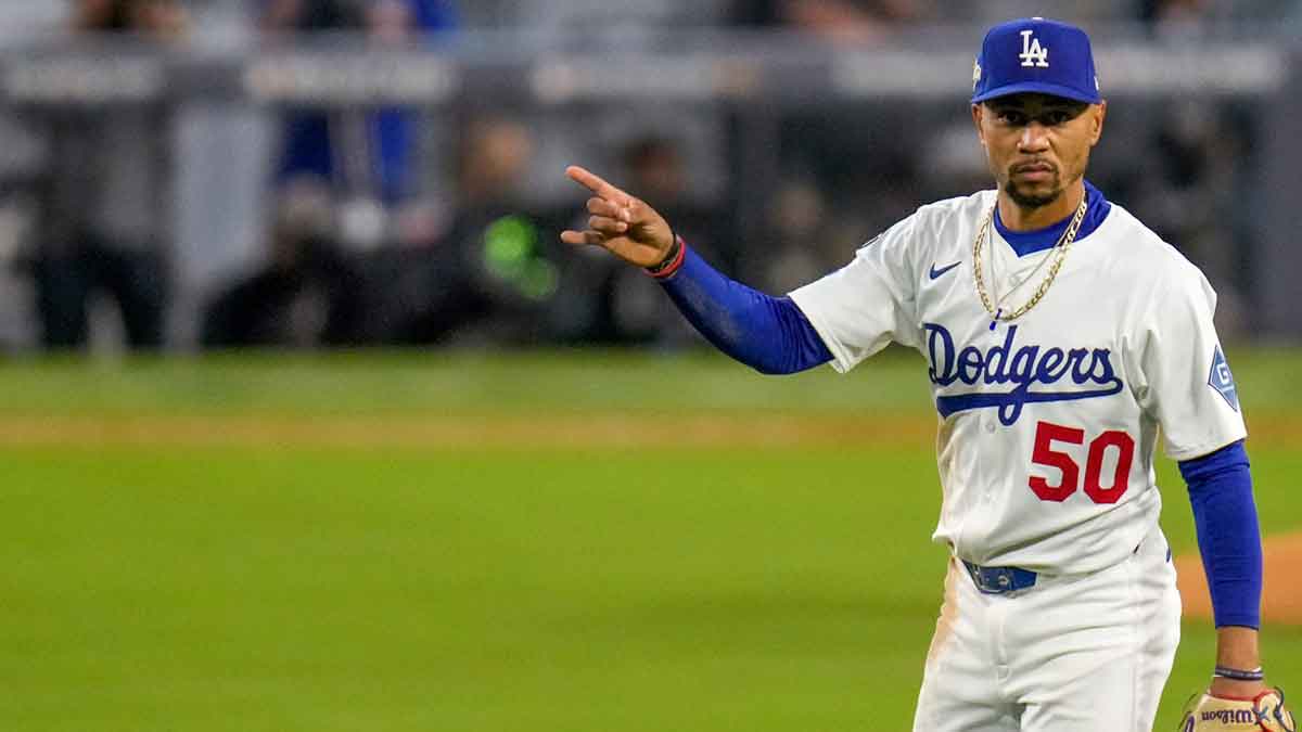 Los Angeles Dodgers shortstop Mookie Betts (50) signals two outs in the fourth inning of the MLB National League Wild Card Game 1 between the Los Angeles Dodgers and the Cincinnati Reds at Dodger Stadium in Los Angeles on Tuesday, Sept. 30, 2025. The Dodgers won game 1 of the series, 10-5.
