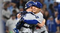 Los Angeles Dodgers pitcher Yoshinobu Yamamoto (18) and catcher Will Smith (16) celebrate after defeating the Toronto Blue Jays in game two of the 2025 MLB World Series at Rogers Centre.