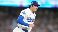Los Angeles Dodgers two-way player Shohei Ohtani (17) reacts after throwing to first for an out against Toronto Blue Jays third baseman Addison Barger (47) in the sixth inning during game four of the 2025 MLB World Series at Dodger Stadium.