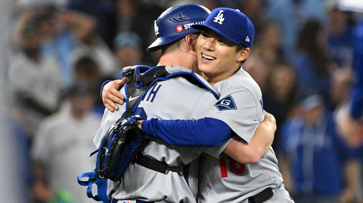 Los Angeles Dodgers pitcher Yoshinobu Yamamoto (18) and catcher Will Smith (16) celebrate after defeating the Toronto Blue Jays in game two of the 2025 MLB World Series at Rogers Centre.