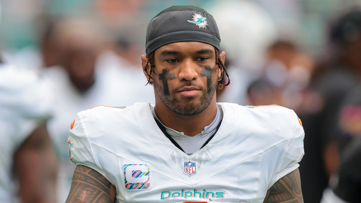 Miami Dolphins quarterback Tua Tagovailoa (1) walks by the bench area against the Los Angeles Chargers during the fourth quarter at Hard Rock Stadium.