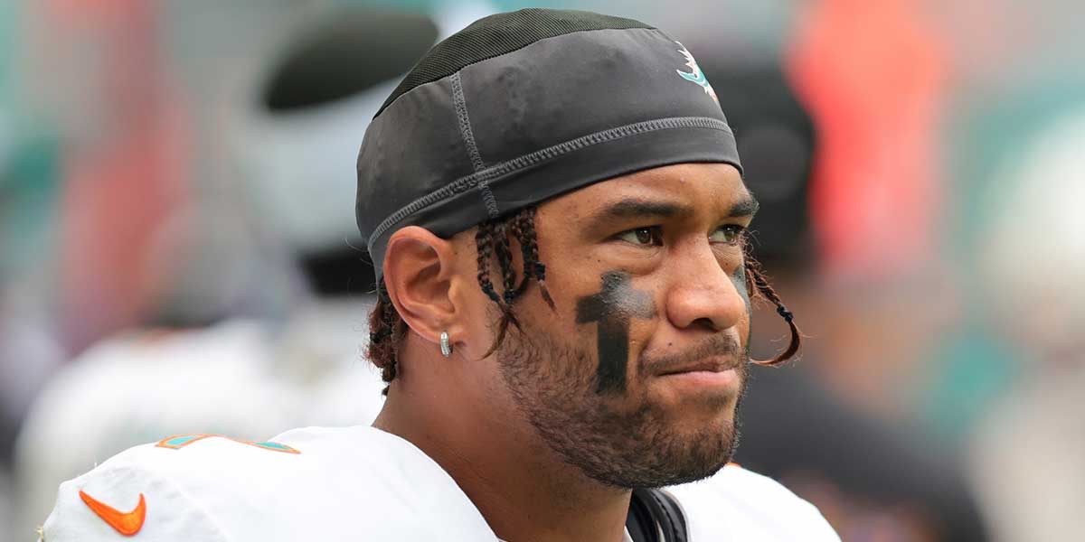 Dolphins quarterback Tua Tagovailoa (1) looks on from thevbench against the Los Angeles Chargers during the fourth quarter at Hard Rock Stadium