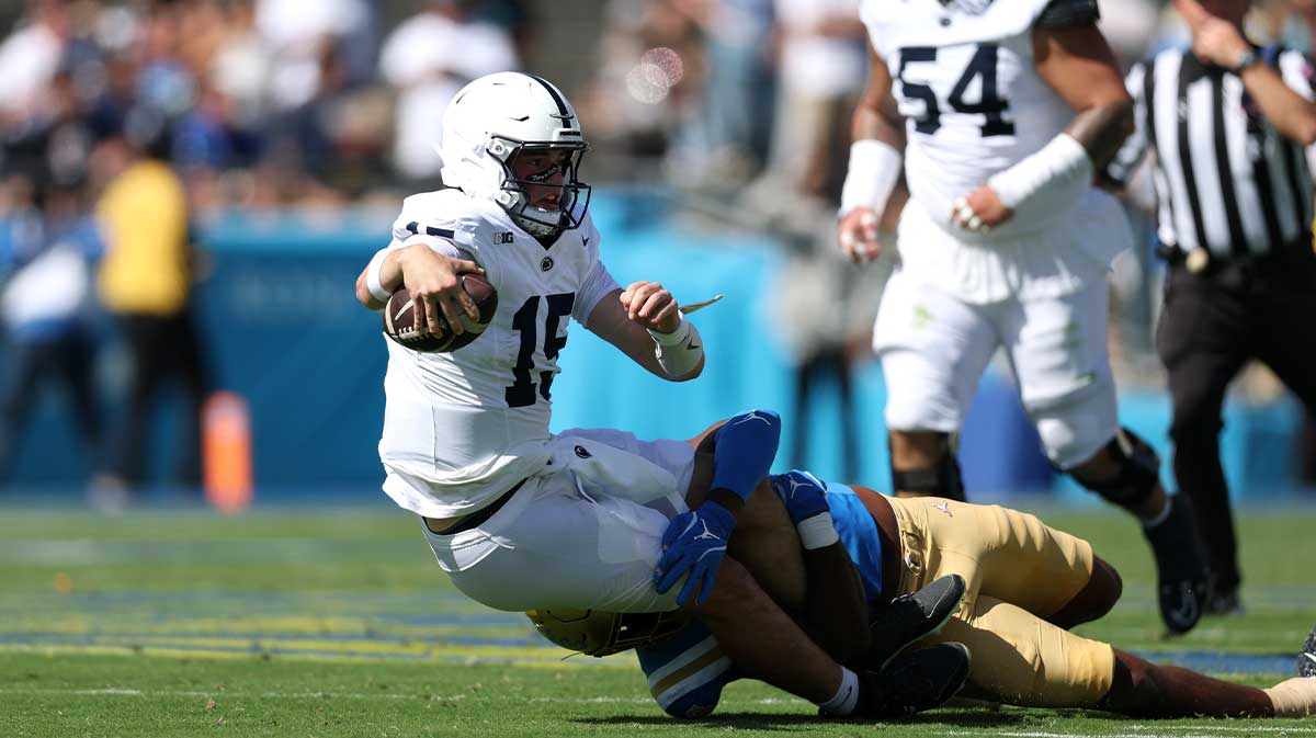 Penn State Nittany Lions quarterback Drew Allar (15) is tackled by UCLA Bruins linebacker Jonjon Vaughns (6) during the second quarter at Rose Bowl. Mandatory Credit: Kiyoshi Mio-Imagn Images