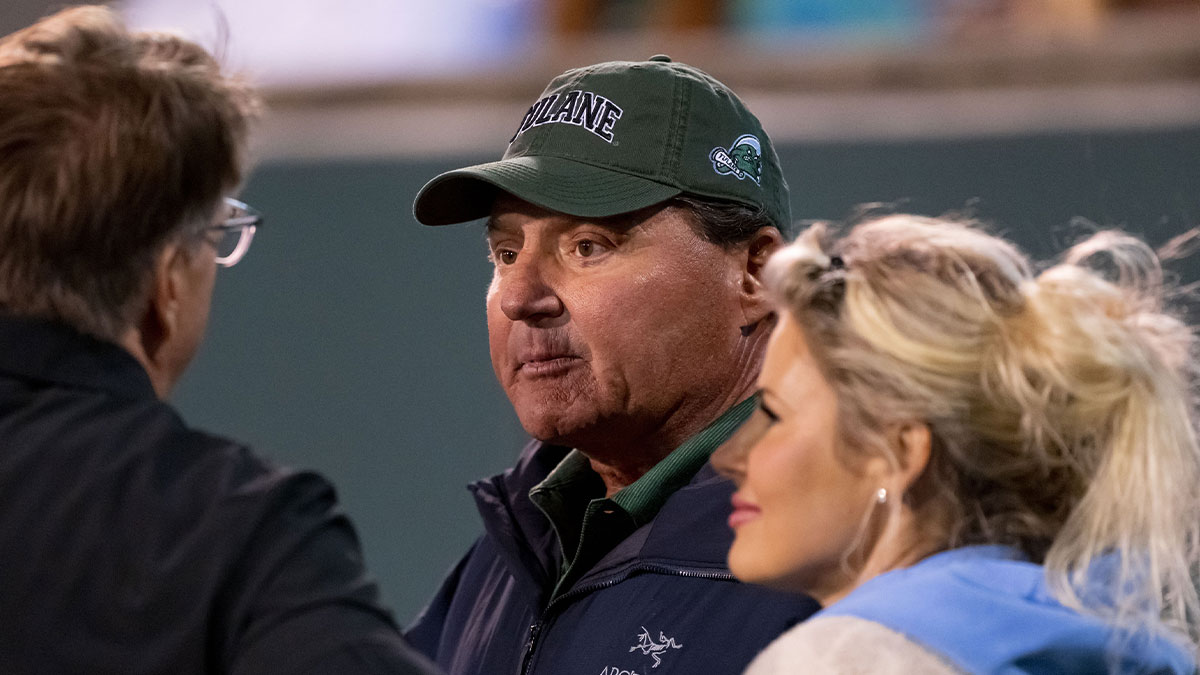 Former LSU head coach Ed Orgeron watches a game between the Tulane Green Wave and the Memphis Tigers with Brandy Nicole, right, during the first quarter at Yulman Stadium.