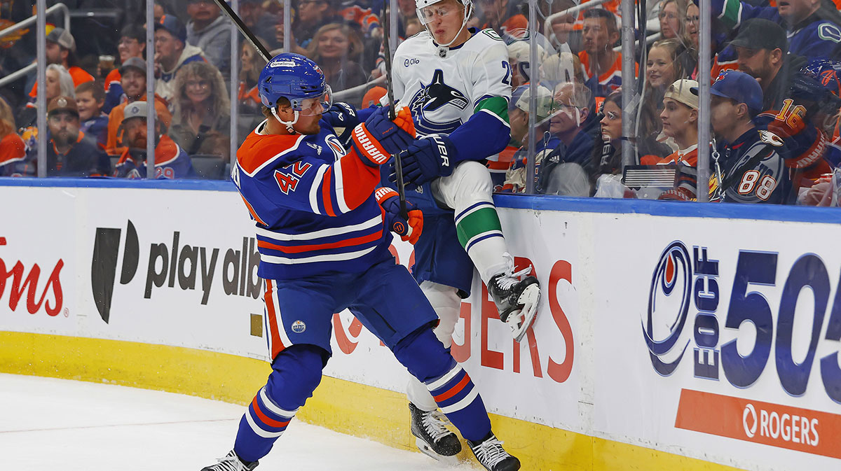 Edmonton Oilers forward Kasperi Kapanen (42)) checks Vancouver Canucks defensemen Elias Pettersson (25) during the first period at Rogers Place.