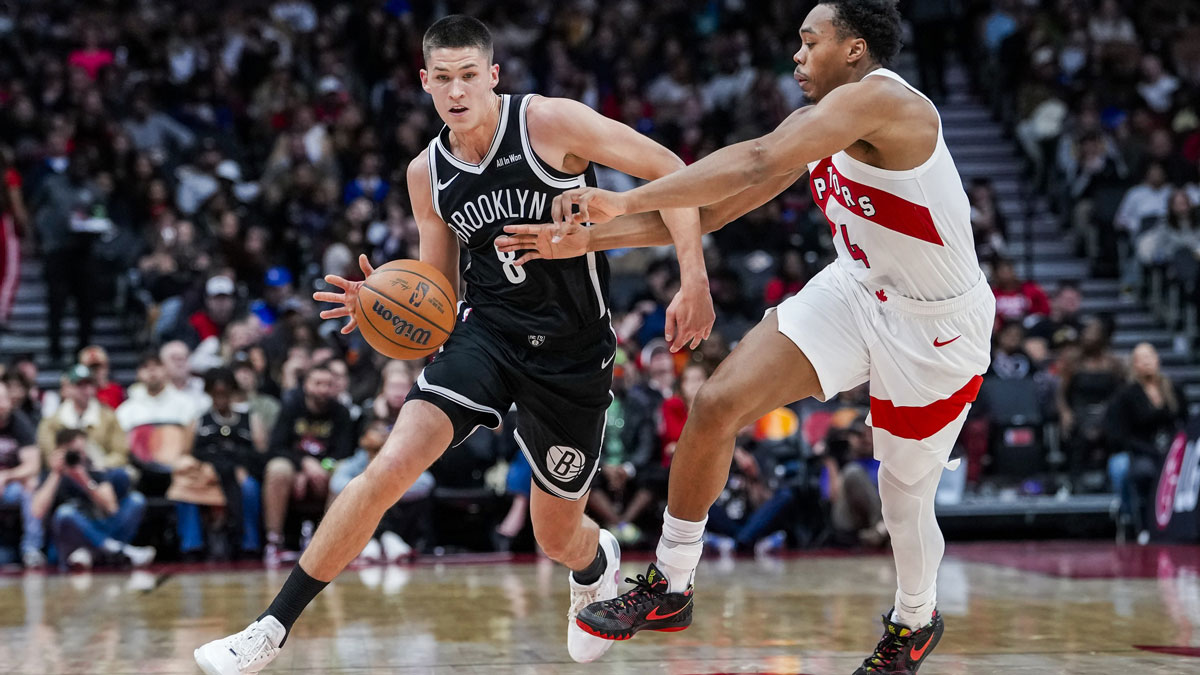 Brooklyn Nets guard Egor Dëmin (8) dribbles the ball against Toronto Raptors forward/guard Scottie Barnes (4) during the second quarter at Scotiabank Arena.