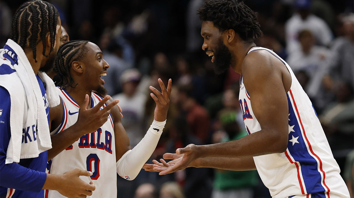 Philadelphia 76ers guard Tyrese Maxey (0) celebrates with 76ers center Joel Embiid (21) during a stoppage in play against the Washington Wizards in overtime at Capital One Arena.