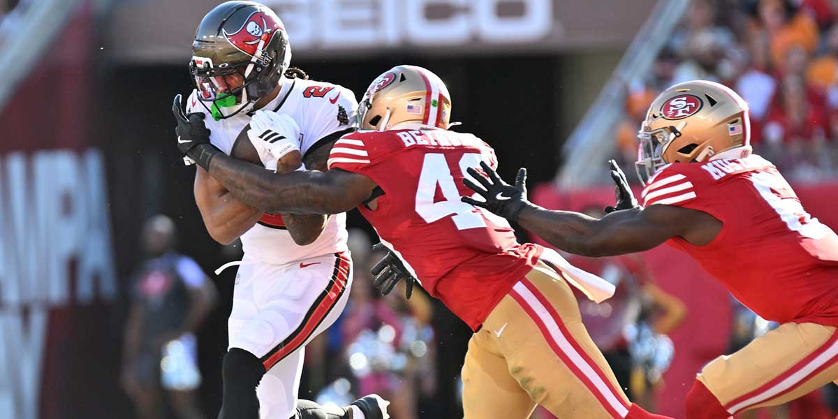 Tampa Bay Buccaneers wide receiver Emeka Egbuka (2) runs for a gain past San Francisco 49ers linebacker Tatum Bethune (48) during the second quarter at Raymond James Stadium.