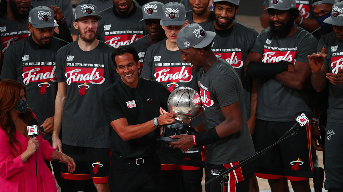 Miami Heat head coach Erik Spoelstra hands the Eastern Conference Championship trophy to forward Bam Adebayo (13) after defeating the Boston Celtics in game six of the Eastern Conference Finals of the 2020 NBA Playoffs at AdventHealth Arena.