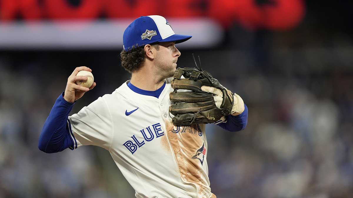 Toronto Blue Jays third baseman Ernie Clement (22) attempts to throw to first in the third inning against the Seattle Mariners during game seven of the ALCS round for the 2025 MLB playoffs at Rogers Centre.