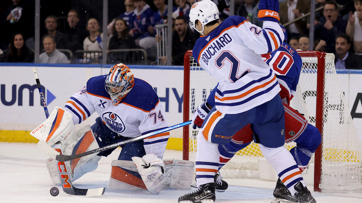 Edmonton Oilers goaltender Stuart Skinner (74) makes a save against New York Rangers left wing Will Cuylle (50) in front of Oilers defenseman Evan Bouchard (2) during the first period at Madison Square Garden.