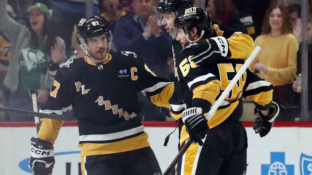 Pittsburgh Penguins center Sidney Crosby (87) and defenseman Kris Letang (58) congratulate center Evgeni Malkin (middle) on his power play goal against the Columbus Blue Jackets during the second period at PPG Paints Arena. The Penguins won 3-2.