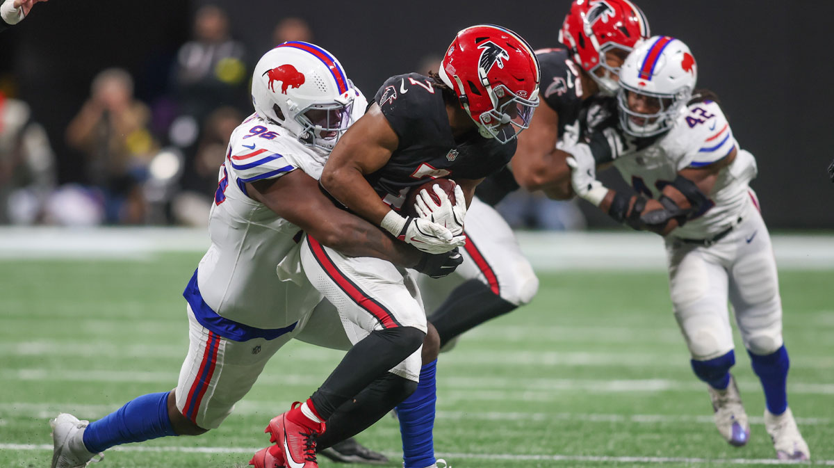 Atlanta Falcons running back Bijan Robinson (7) is tackled by Buffalo Bills defensive tackle Deone Walker (96) during the second half of a game at Mercedes-Benz Stadium.