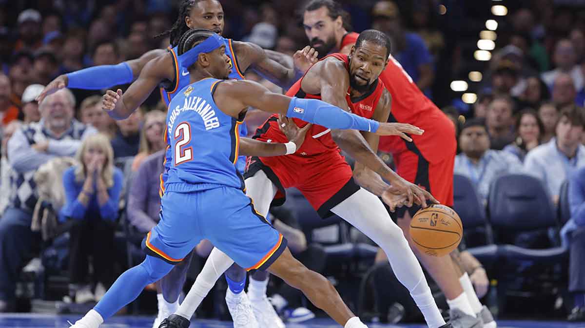 Houston Rockets forward Kevin Durant (7) passes around Oklahoma City Thunder guard Shai Gilgeous-Alexander (2) during the first half at Paycom Center.