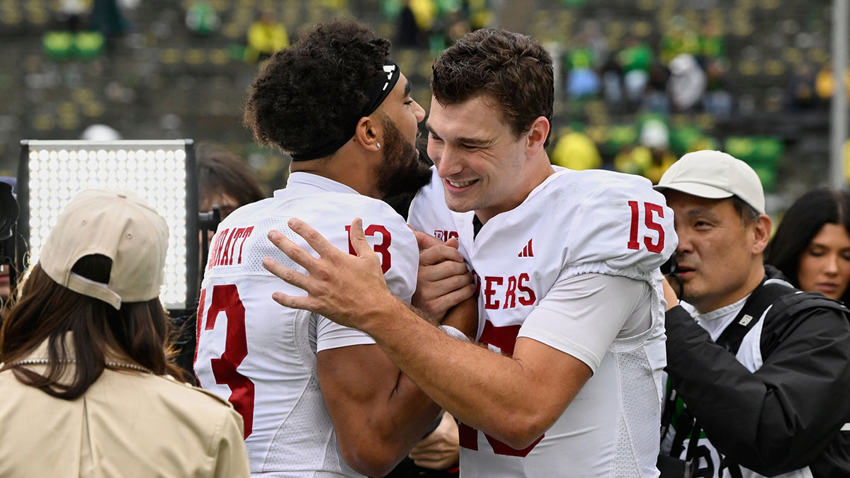 Indiana Hoosiers wide receiver Elijah Sarratt (13) and quarterback Fernando Mendoza (15) celebrate after defeating the Oregon Ducks by the score of 30-20 at Autzen Stadium.